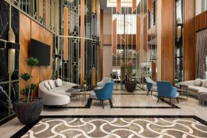 a lobby with couches and chairs in a building at TRYP by Wyndham Istanbul Maltepe in Istanbul