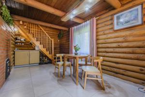 ein Esszimmer mit einem Tisch und Stühlen sowie Holzwänden in der Unterkunft Bedugnės pirtelė - Cosy Sauna House in Vilnius