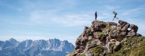 two people standing on the top of a mountain at Marias Alpen Apartment by Alpine Host Helpers in Brixen im Thale