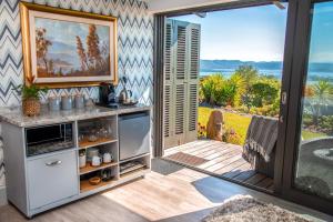 a kitchen with a view of the ocean at Pezula Magic Escape - Guest House - No Loadshedding in Knysna +31 photos