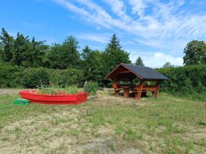 un tavolo e una barca in un campo con un gazebo di NEU! Ferienwohnung am Grimnitzsee a Joachimsthal