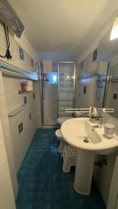 a bathroom with a sink and two toilets and a shower at La maison b8 in Rome