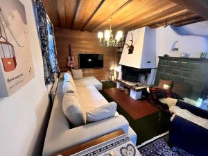 a living room with a couch and a tv at Chalet Levi by Alpine Host Helpers in Kirchberg in Tirol