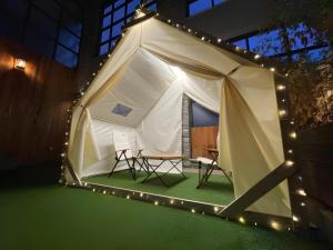 a white tent with two chairs and lights at The Classic by Hotelone in Jeonju