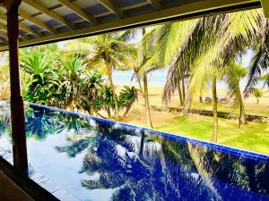 a view of a swimming pool from a resort window at Sri Lanka Beach House Hotel and SPA in Hikkaduwa