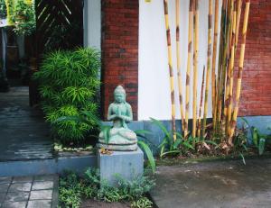 eine Statue vor einem Gebäude neben einem Gebäude in der Unterkunft ThanTha Ubud Villa in Ubud
