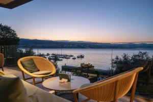 a balcony with chairs and tables and a view of the water at Amadria Park Grand Hotel 4 Opatijska Cvijeta in Opatija