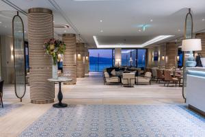 a lobby of a hotel with tables and chairs at Amadria Park Grand Hotel 4 Opatijska Cvijeta in Opatija +37 photos