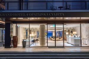 a store front of a building with glass doors at Amadria Park Grand Hotel 4 Opatijska Cvijeta in Opatija
