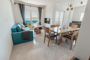 a living room with a blue couch and a table at Elia apartments in Ražanj