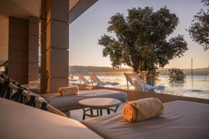 a group of beds with a view of the water at Amadria Park Grand Hotel 4 Opatijska Cvijeta in Opatija