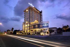 a large building with lights on top of it at night at Le Maritime Kochi in Cochin