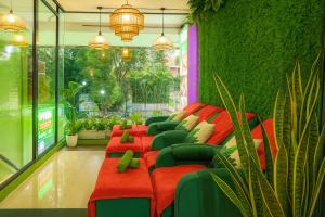a row of red chairs in a room with plants at Hoang Phi Saigon Hotel & Spa in Ho Chi Minh City