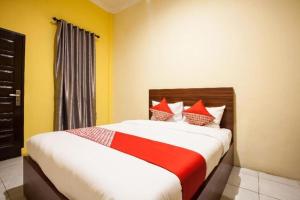 Postel nebo postele na pokoji v ubytování Hotel O Bunga Raya Residence