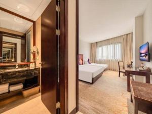 a living room with a white couch and a table at Huading International Hotel in Hangzhou