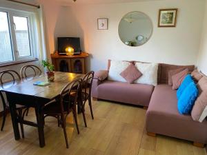 a living room with a couch and a table at Seaview in Duneen +14 photos