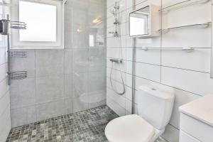 a white bathroom with a toilet and a shower at La tranquilité bleue - Maison avec Parking cloturé in Les Sables-dʼOlonne +40 photos