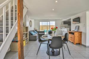a kitchen and living room with a table and chairs at La tranquilité bleue - Maison avec Parking cloturé in Les Sables-dʼOlonne