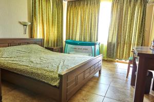 a bedroom with a bed and a chair in it at Villa Katalina in Varna City