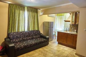a living room with a couch and a kitchen at Villa Katalina in Varna City