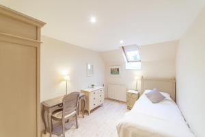 a bedroom with a bed and a desk and a desk at Penninghame Estate - Bruce Apartment in Challoch
