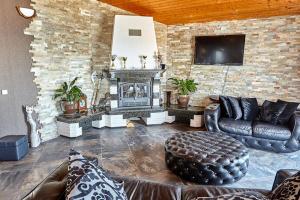 a living room with a couch and a fireplace at Villa Katalina in Varna City