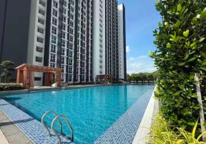 a large swimming pool with tall buildings in the background at Apartment in Kajang WIFI Smart TV in Kajang