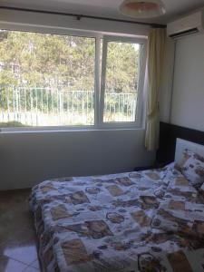 A bed or beds in a room at Caprice Apartment in Lozenec