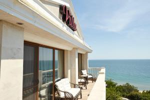 a hotel room with a balcony overlooking the ocean at Villa Katalina in Varna City