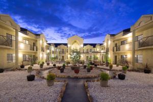 a courtyard of a building with potted plants at Canberra Parklands Central Apartment Hotel Official in Canberra