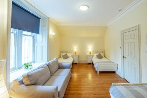 a living room with two couches and a large window at Penninghame Estate - Stewart Apartment in Challoch