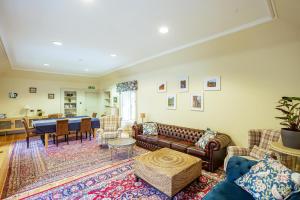 a living room with a couch and a table at Penninghame Estate - Stewart Apartment in Challoch