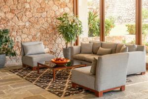 a living room with two chairs and a couch and a table at Amalia Hotel Delphi in Delphi
