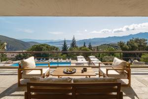 a patio with a view of the mountains at Amalia Hotel Delphi in Delphi