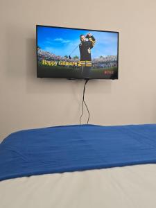 a flat screen tv hanging on a wall at Apartment with Balcony near ICC On Dixon street in Sydney