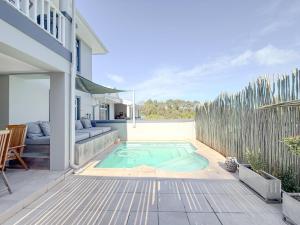 a swimming pool in the middle of a patio at Kloof Gardens: Pool Braai with Lagoon Views in Knysna