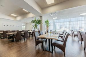 a dining room with tables and chairs at Residence Šírava *** in Kaluža