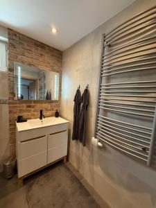 a bathroom with a sink and a mirror at Dom pod hradom s kinom a saunou  +10 photos