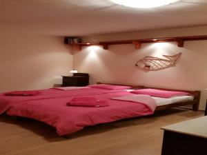 a bedroom with two beds with red sheets at Rustic Apartment in Vis with sea-view in Vis