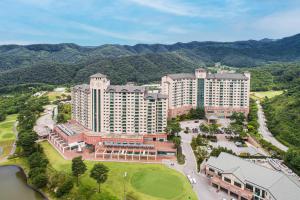 an aerial view of a resort with mountains in the background at OakValley Resort Hills Village in Wonju