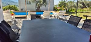 a table and chairs in front of a pool at Owl's Nest in Bar