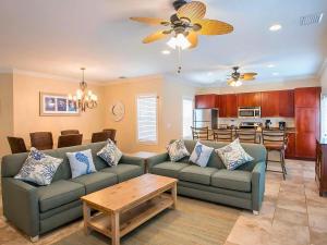 a living room with two couches and a kitchen at Hawks Cay Resort in Marathon