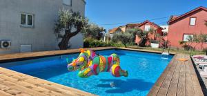 a small swimming pool with a colorful inflatableentity in the water at Owl's Nest in Bar