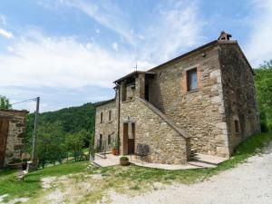 an external view of a stone building with trees in the background at Beautiful Apartment in Sestino with Garden in Sestino