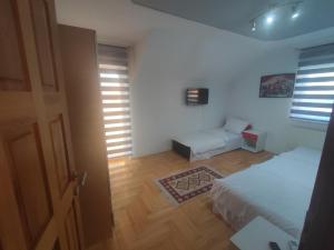 a bedroom with a bed and a couch and a window at Villa Hills in Sarajevo +72 photos