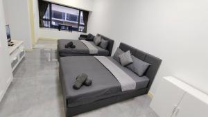 a bedroom with a large bed and a couch at Imperio A1705 with Bathtub 4pax free Wifi Parking in Malacca