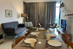 a living room with a couch and a table and chairs at Beacon Executive Suites in George Town