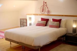 a bedroom with a large white bed with red pillows at Enjoy Lisbon Alfama 2 in Lisbon