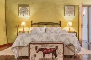 a bedroom with a bed with a horse on a box at Casa Isabel in Santa Brígida