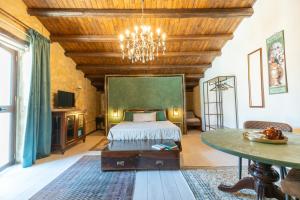 a bedroom with a bed and a chandelier at Feudo Nobile in Gela